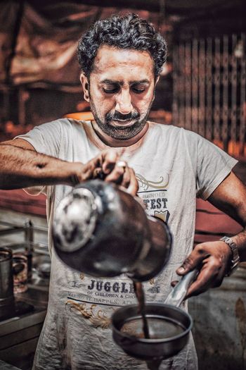Man pouring tea at market