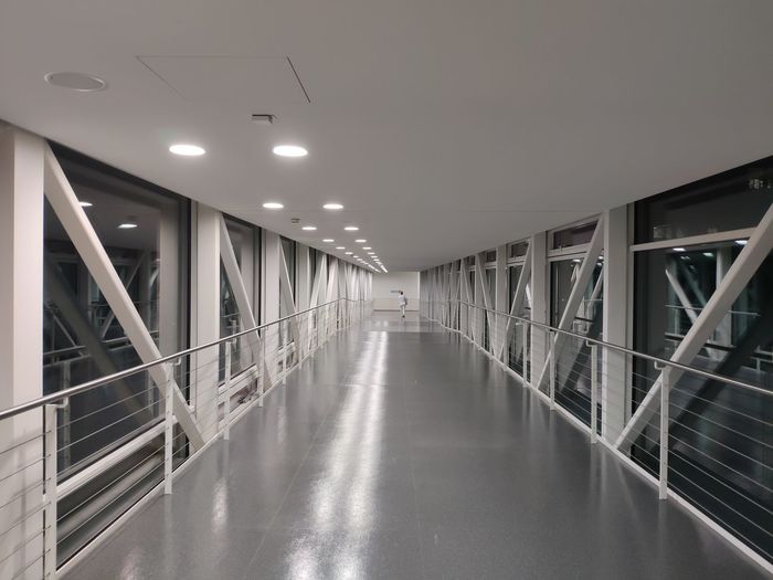 Empty illuminated corridor of building
