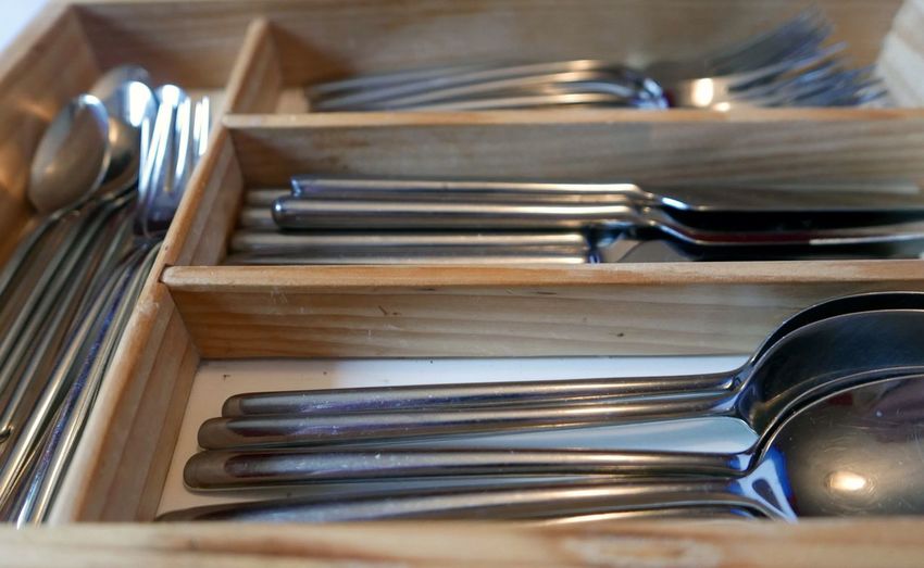 High angle view of cutlery in cabinet