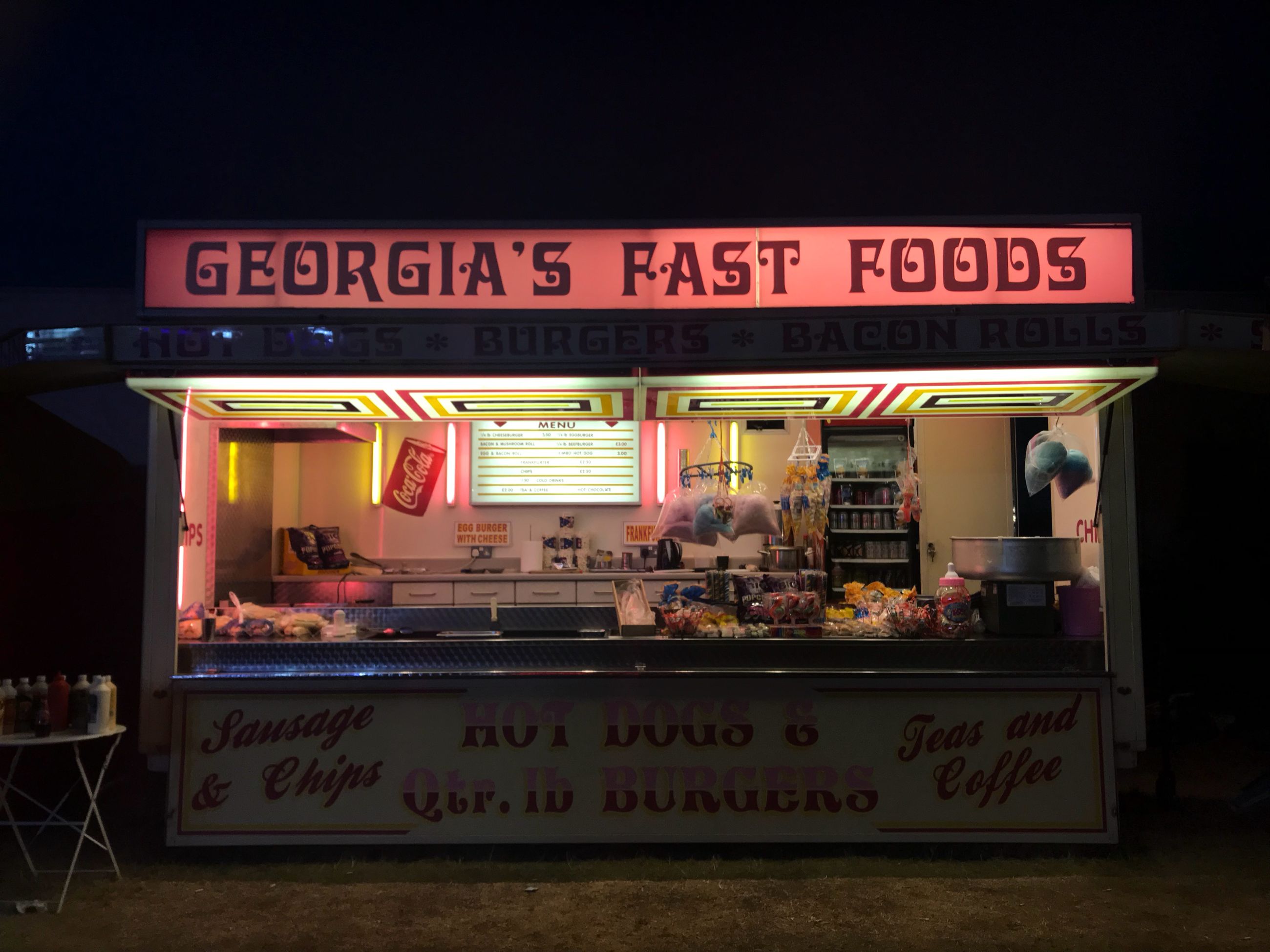 text, communication, western script, food and drink, sign, food, illuminated, store, script, night, no people, non-western script, unhealthy eating, information, architecture, restaurant, business, number, information sign, neon, snack