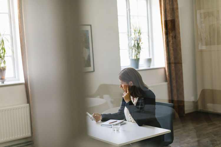Mature woman sitting at desk