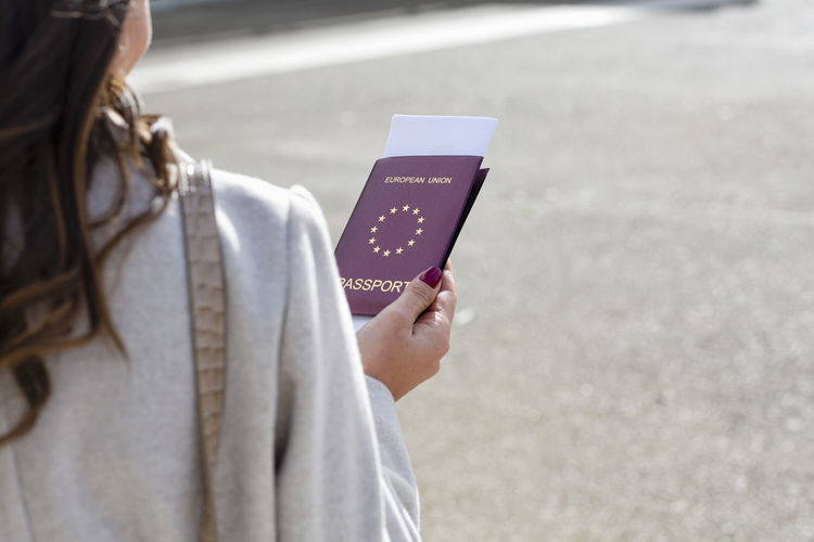 Woman on business trip holding passport