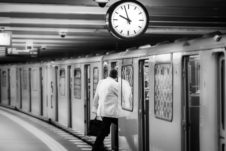 Man getting into subway train at night
