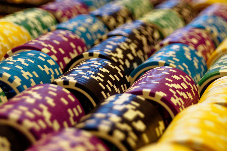 Close-up of multi colored gambling chips by poker game
