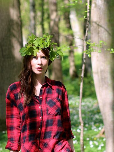 Portrait of a young woman standing in forest