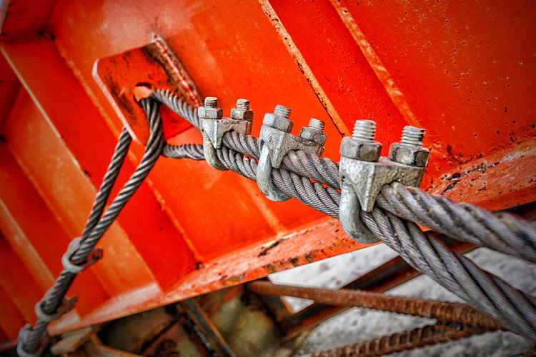 Close-up of steel cable tied on metal container