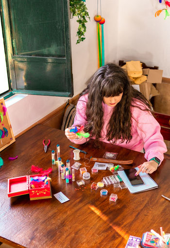 High angle view of girl playing with toys on table