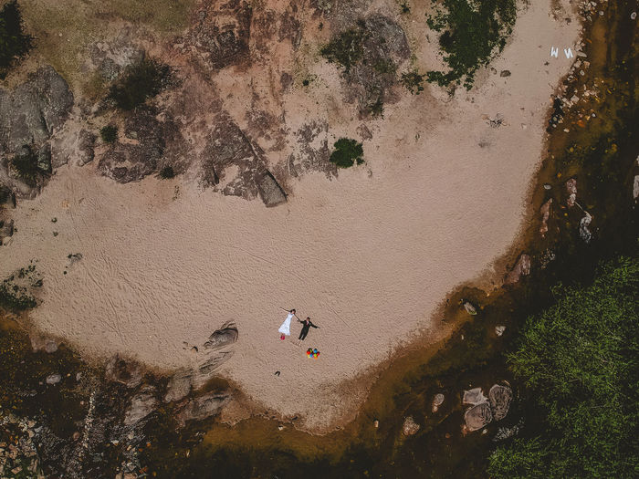 Aerial view of man and woman relaxing on beach
