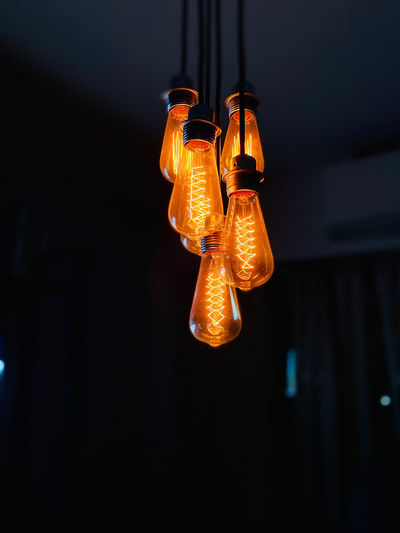 Low angle view of illuminated light bulb at home