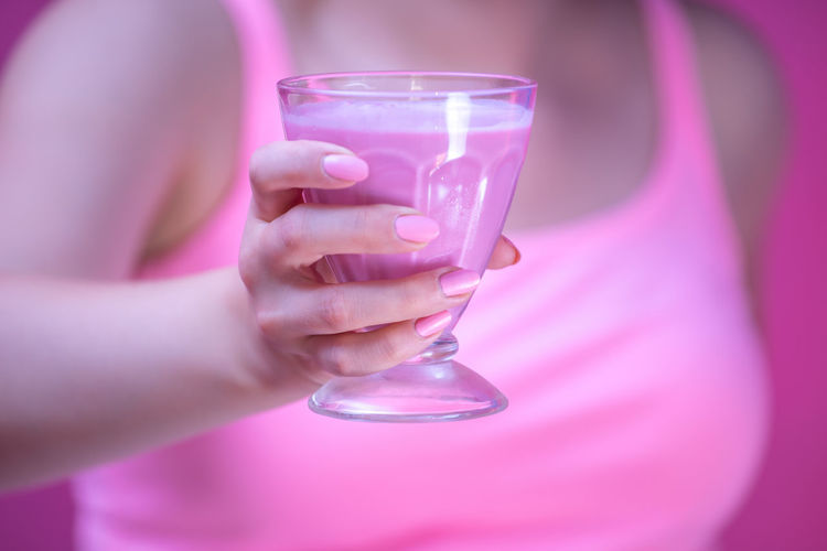 Midsection of woman drinking glass