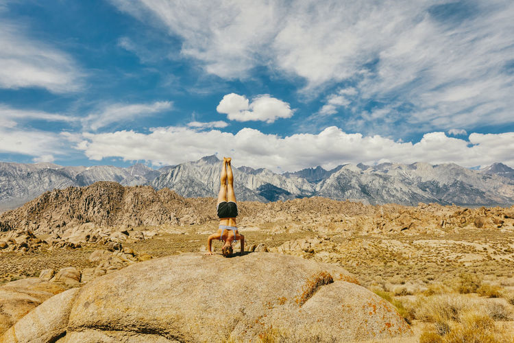 Young woman practicing yoga near alabama hills in northern california.
