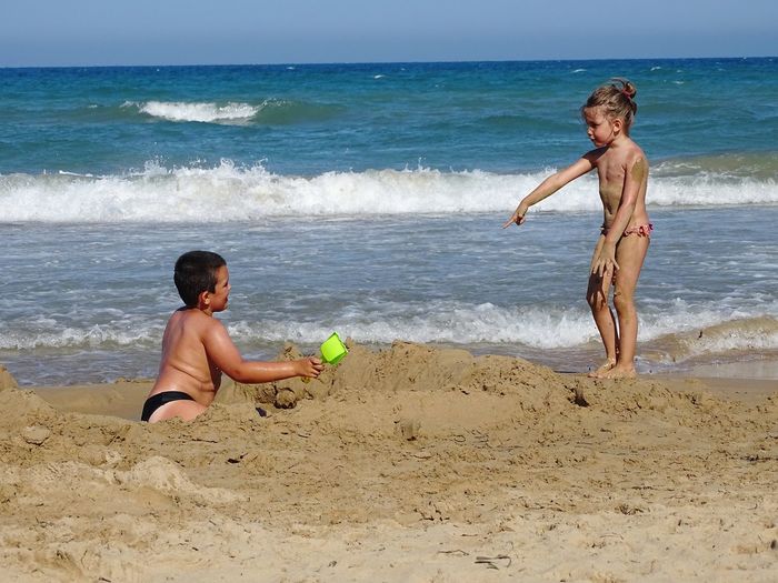 Full length of a boy playing on beach