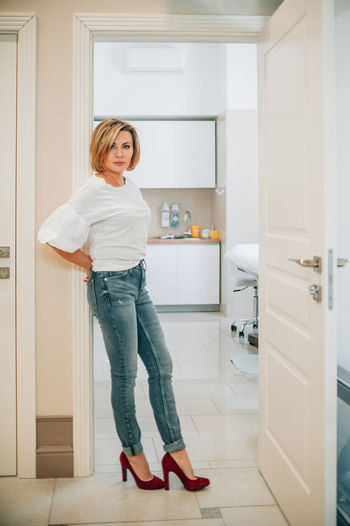 Side view of young woman standing in bathroom