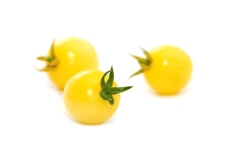 Close-up of yellow fruit against white background