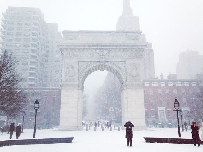 Low angle view of washington square arch and buildings in foggy weather