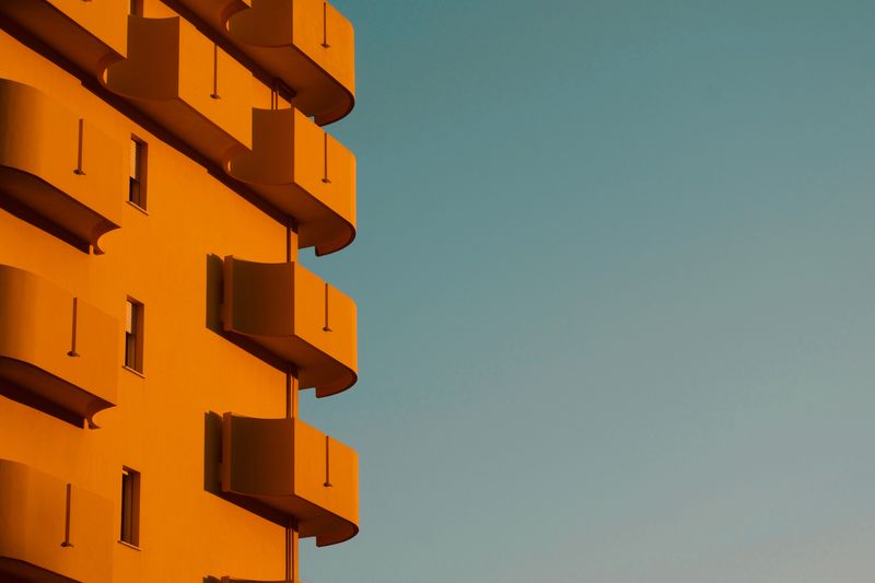 Low angle view of orange tower against clear sky