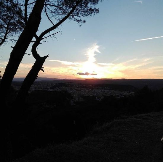 Scenic view of landscape against dramatic sky during sunset