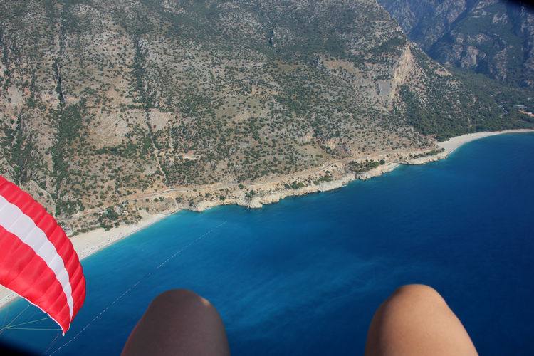 Cropped image of woman paragliding over sea