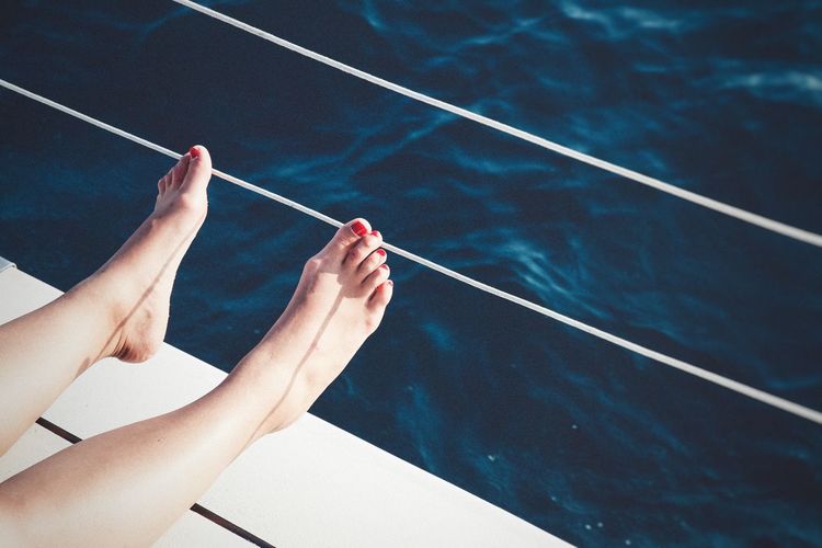 Close-up of female feet on yacht