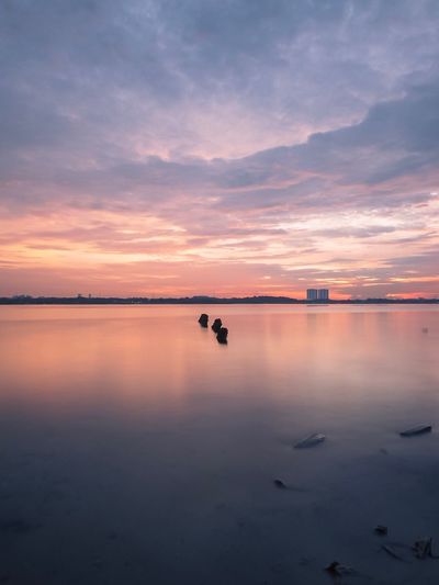 Scenic view of lake against sky during sunset
