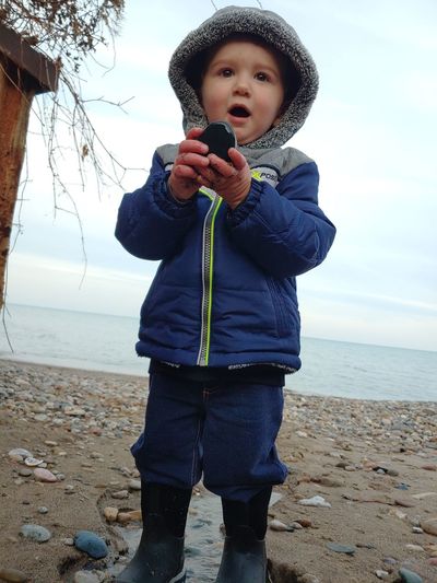 Full length of boy standing on beach