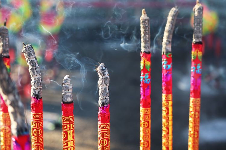 Close-up of multi colored incense in temple