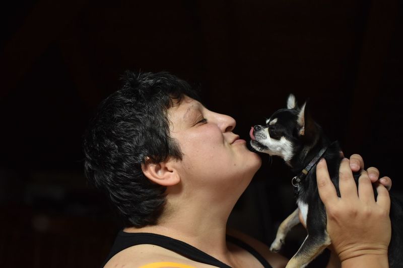 Portrait of woman holding dog