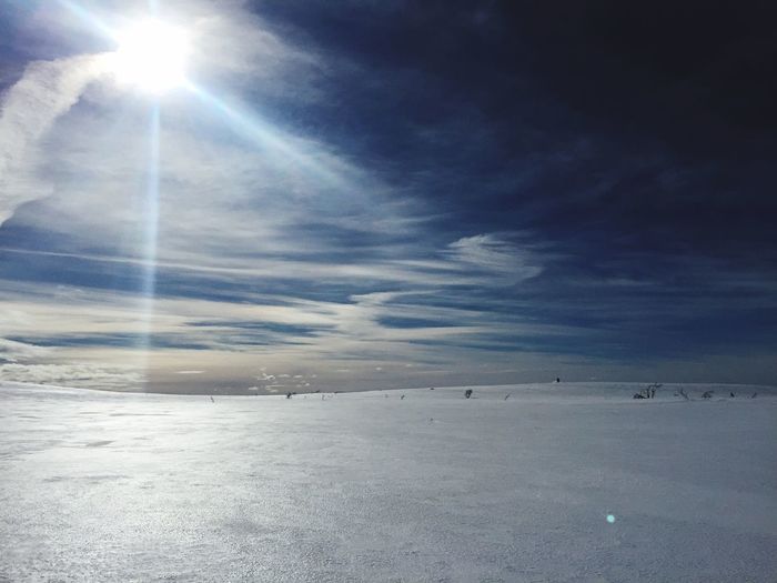 Scenic view of frozen landscape against sky