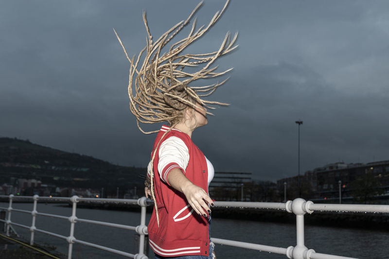 Blonde woman with dreadlocks wagging her hair