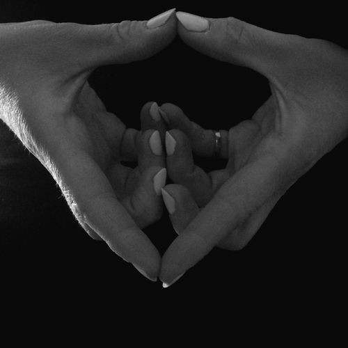 Close-up of hand over black background