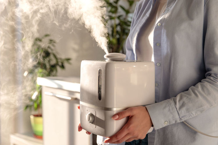 Close-up of woman holding humidifier