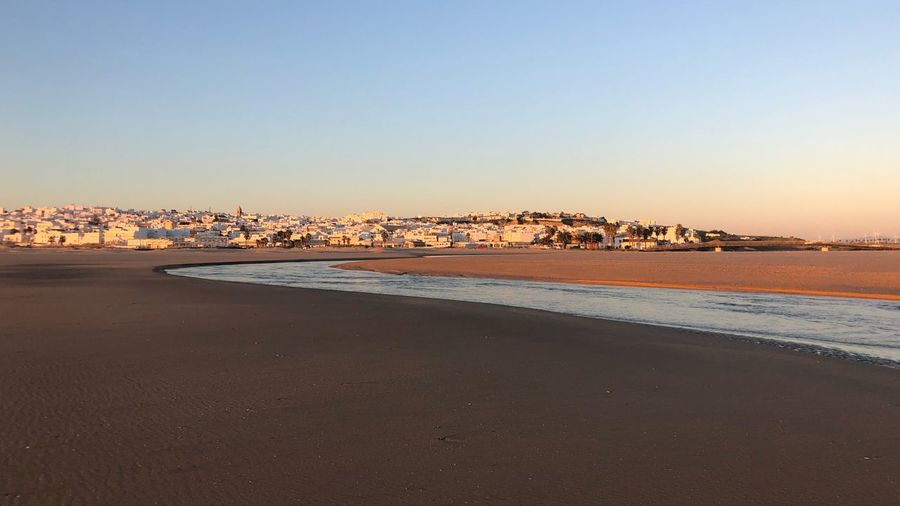 Scenic view of sea against clear sky during sunset