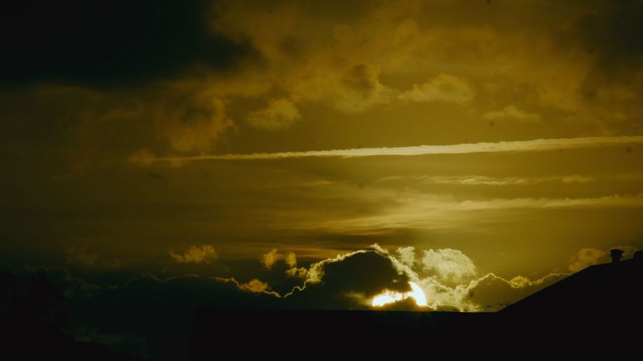 Low angle view of dramatic sky during sunset