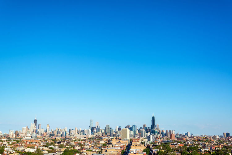 View of cityscape against blue sky