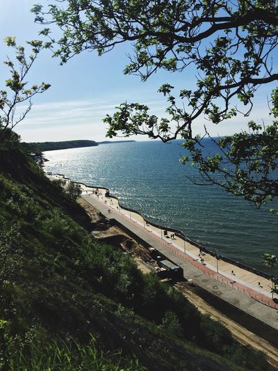 High angle view of sea and trees against sky
