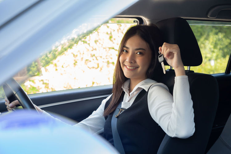 Portrait of happy woman in car