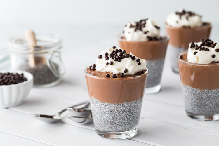 Chocolate mousse chia pudding parfaits with ingredients to the left.