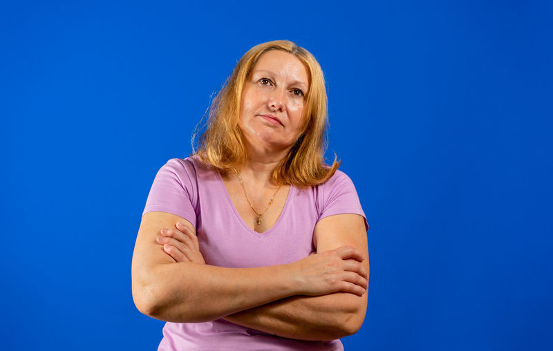 Portrait of a woman against blue background
