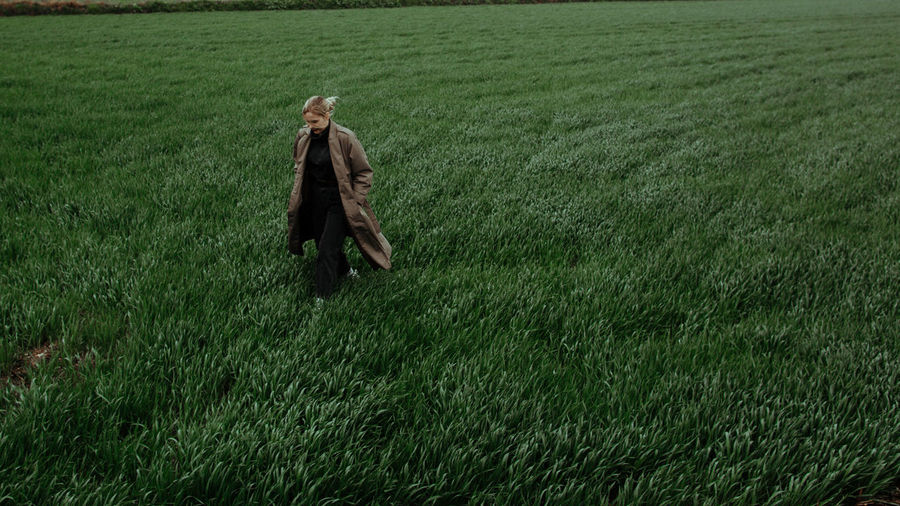 High angle view of young woman walking on grassy land