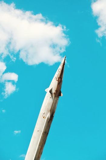 Low angle view of rocket against blue sky