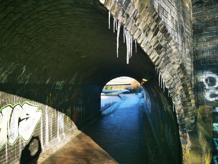 Arch bridge over canal in tunnel