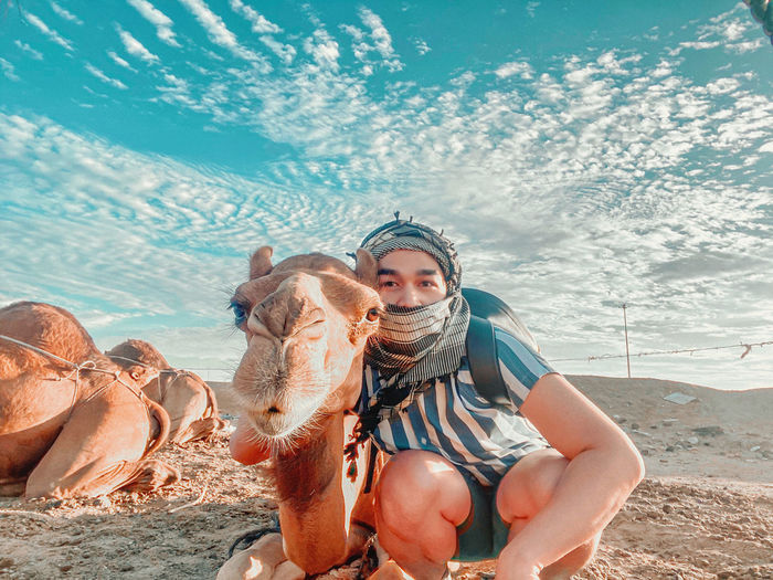 Man with camel at desert 