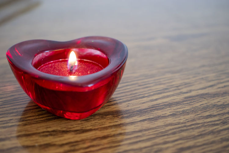 Close-up of red candle on table