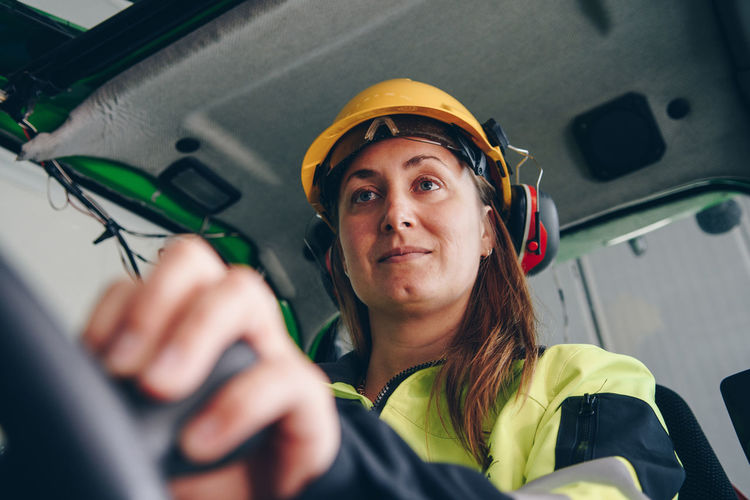 Woman driving construction vehicle