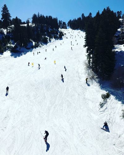 High angle view of people skiing on snow covered mountain