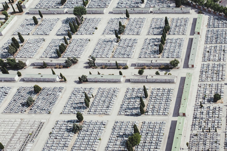 From above aerial drone view shot of cemetery graveyard in the middle of the city