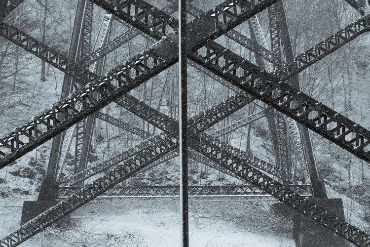 Symmetric closeup of the base of the cap-rouge 1908 railway trestle bridge covered in a light  snow
