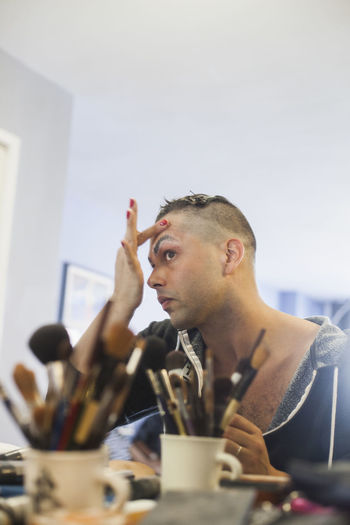 Man applying drag makeup