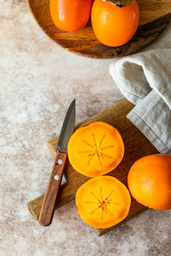 High angle view of orange fruits on cutting board