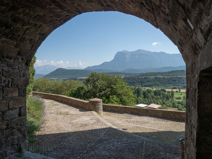 Scenic view of mountain seen through arch
